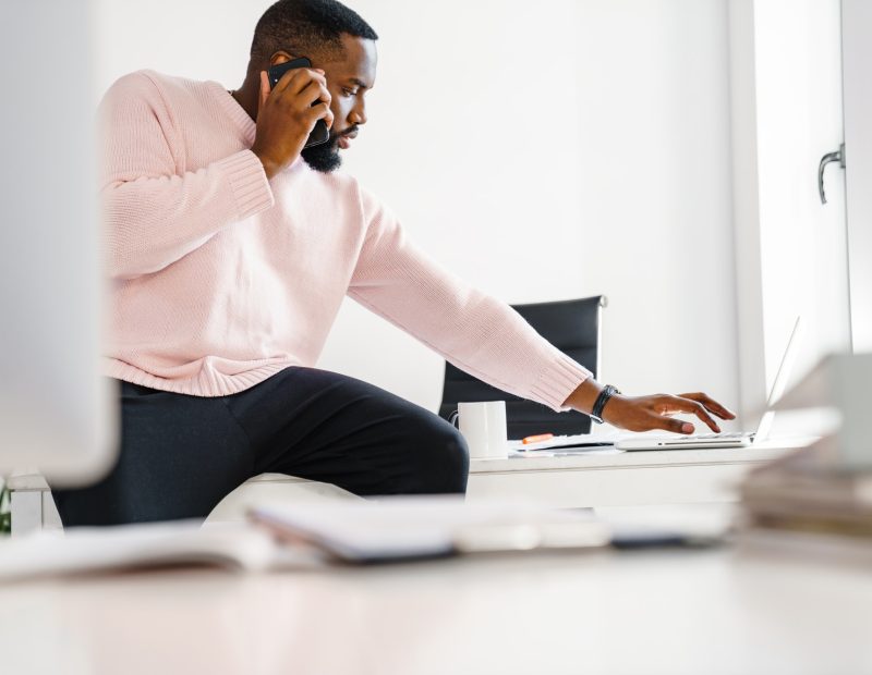 Confident young african business man working